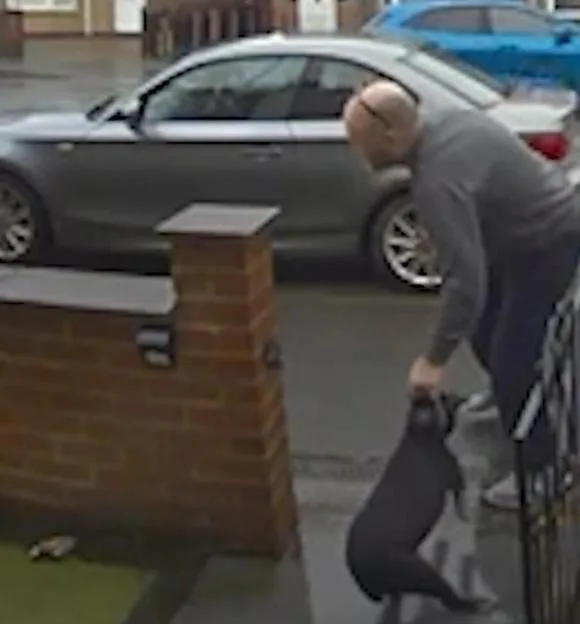 CCTV still showing a man dragging his elderly Patterdale Terrier dog, Milo, by the collar.