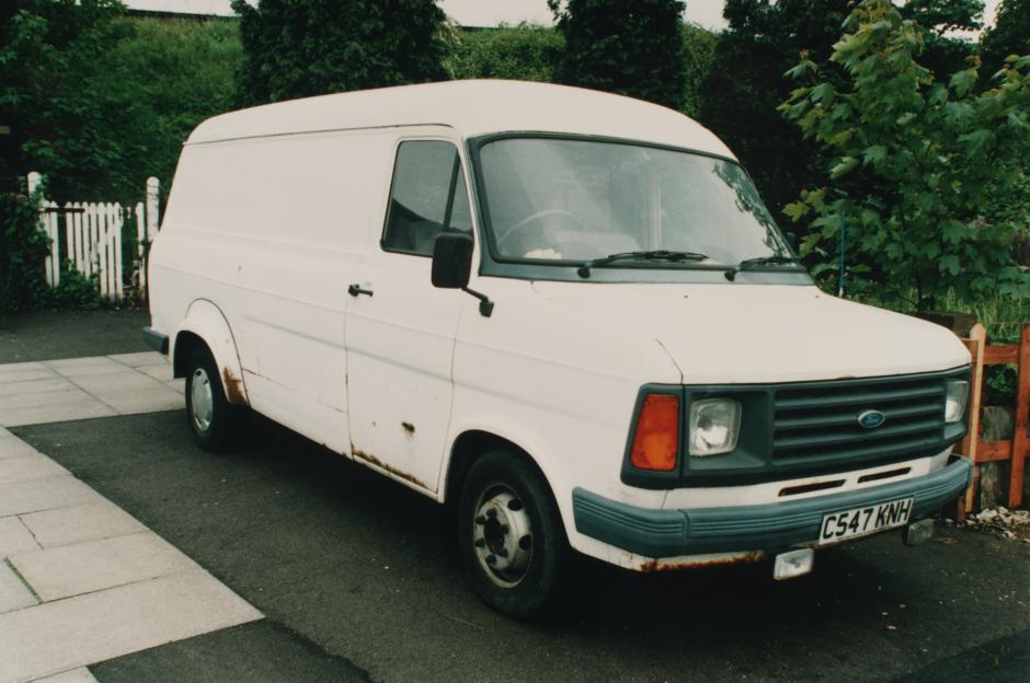 A white Ford Transit van, similar to one used by Robert Black, is parked on a paved surface.