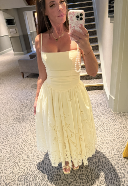 Katie Bailey in a long, flowing yellow dress.