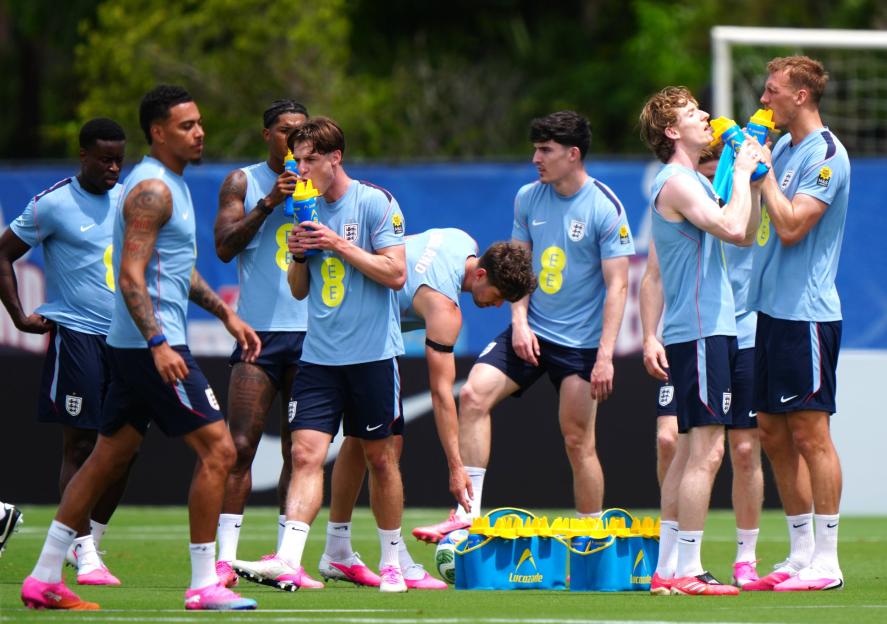 England national football team players rehydrating during a training session.
