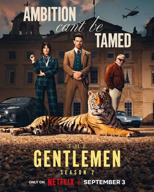 The Gentlemen Season 2 poster featuring Kaya Scodelario, Theo James, and Ray Winstone, with a tiger in the foreground and a large house in the background.