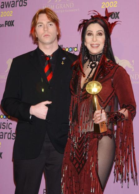 Cher holding a gold award next to her son Elijah Blue Allman.