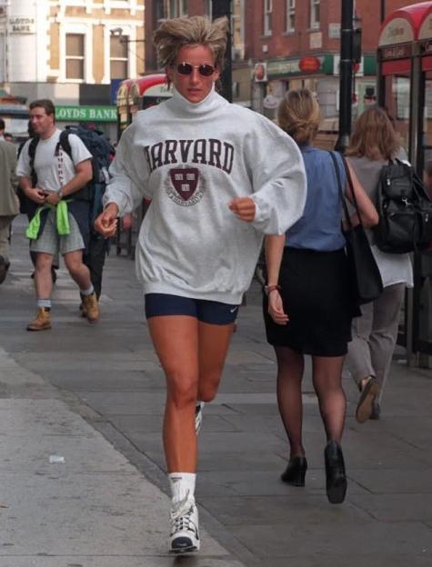 Diana, Princess of Wales, in a Harvard sweatshirt and sunglasses, sprints away from a gym in London.