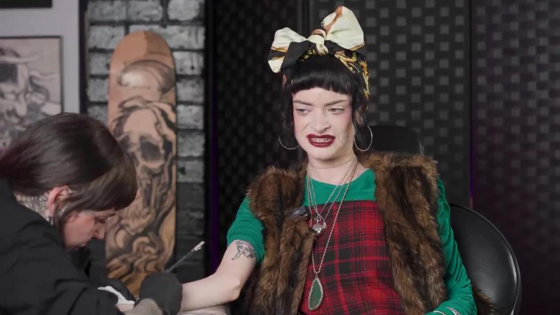 Ruth Codd reacts to getting a tattoo on her arm.