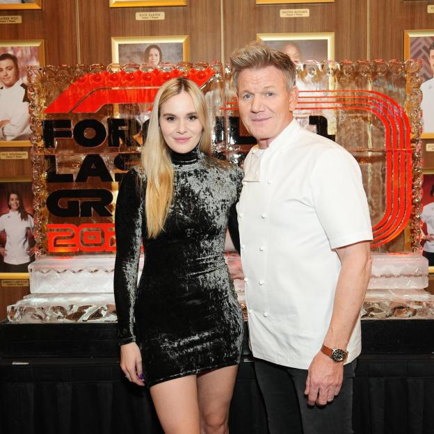 Holly and Gordon Ramsay posing together in front of an ice sculpture.