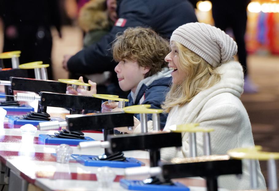 Kate Garraway and her son playing a carnival game.