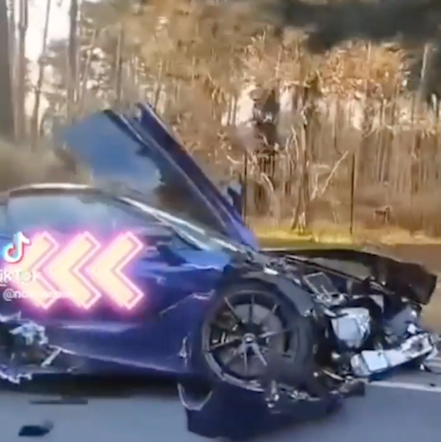 A blue McLaren supercar after being destroyed in a horror crash.