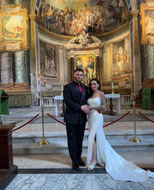 A couple stands in a church for their wedding.