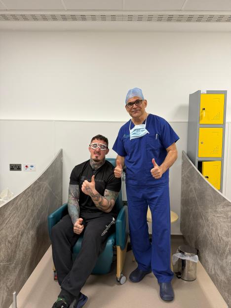 Tom Aspinall and an Optegra doctor giving thumbs up after an eye operation.