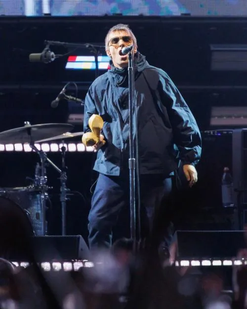 Liam Gallagher of Oasis performing on stage at the Rose Bowl.