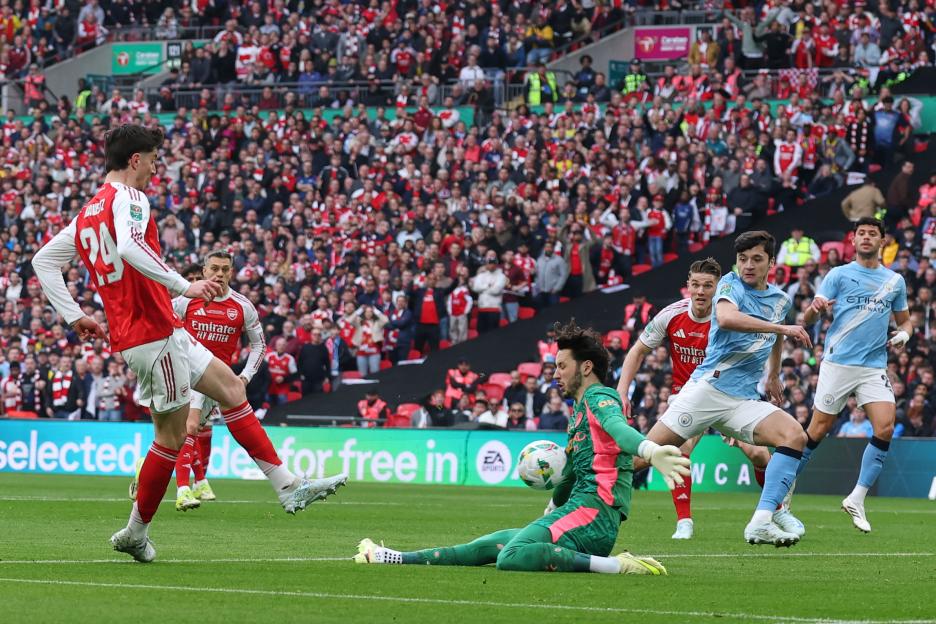 Manchester City's goalkeeper James Trafford saves a shot from Arsenal's Kai Havertz during the English League Cup final soccer match.
