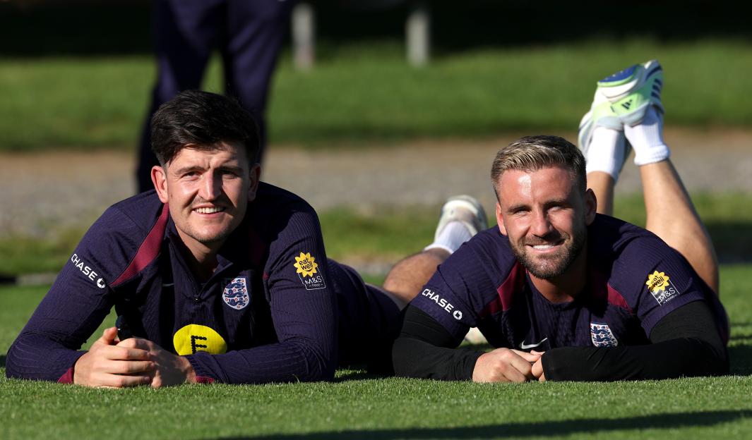 Harry Maguire and Luke Shaw of England on the grass during a training session.