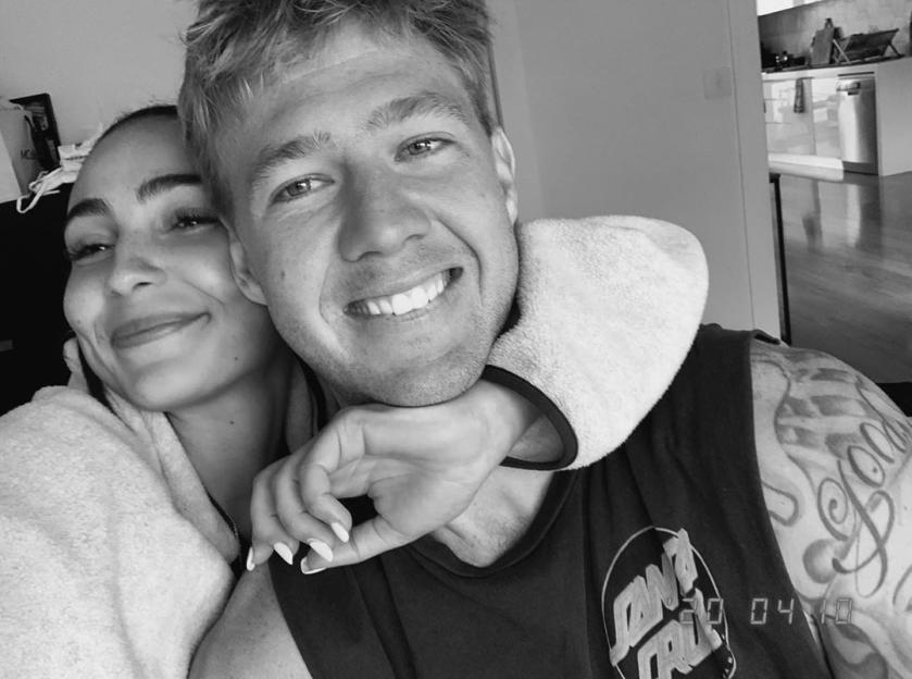 Tayla Damir and Nathan Broad posing closely together.