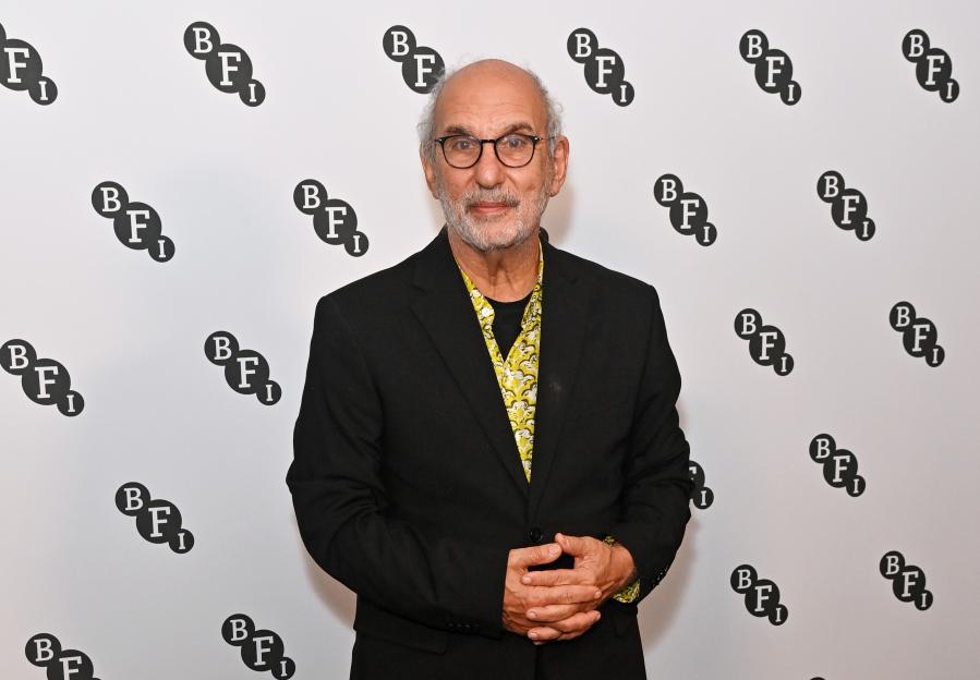 Alan Yentob holding his Commander of the Order of the British Empire medal.