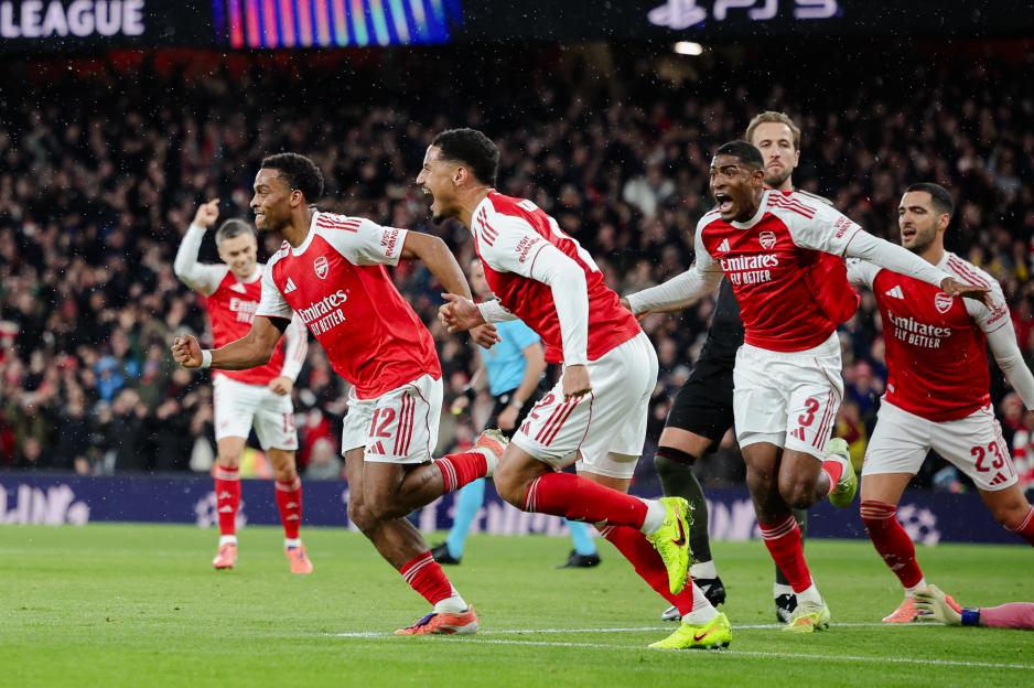 Arsenal players celebrating after scoring a goal.