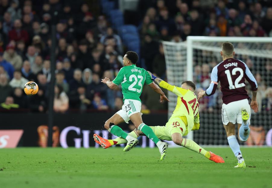 Aston Villa goalkeeper Marco Bizot fouls Newcastle United's Jacob Murphy.