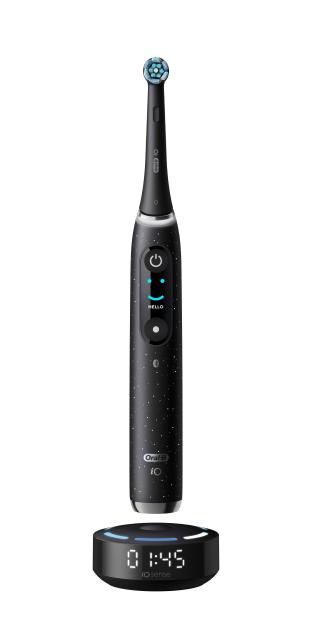 Oral-B iO Series 9 electric toothbrush in black with a digital display showing "Hello" and a charging base displaying "01:45".