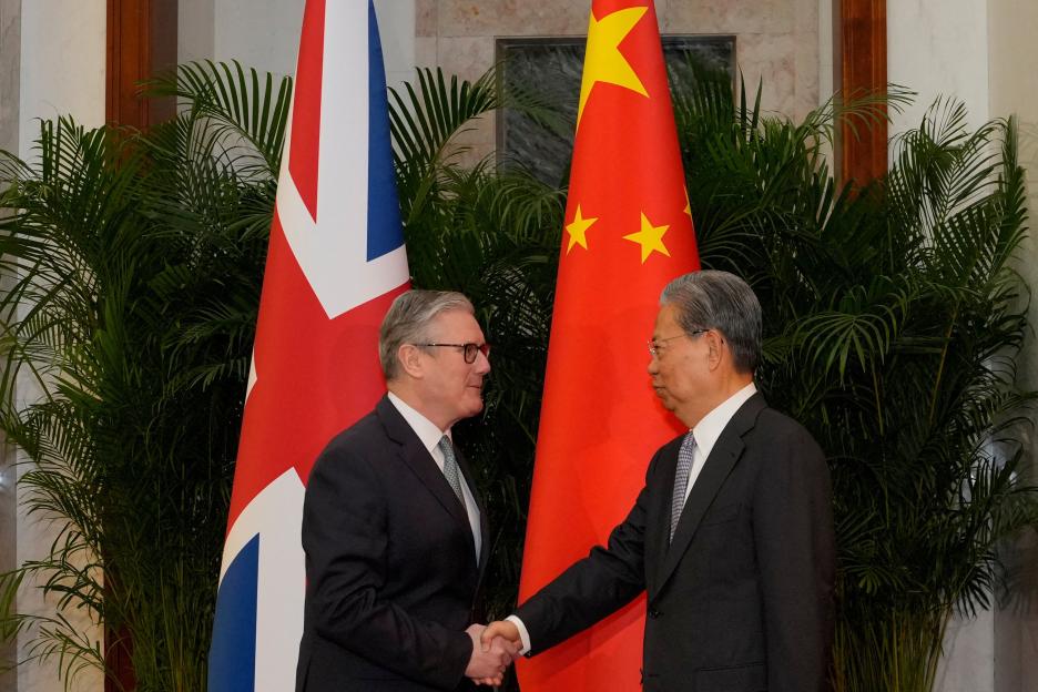 Britain's Prime Minister Keir Starmer shaking hands with National People's Congress Chairman Zhao Leji.