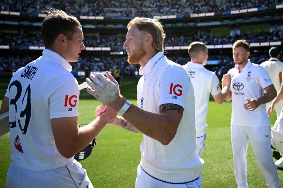 England cricketers Smith and Stokes shaking hands on the field after a match.