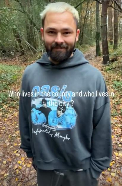 Man in Oasis hoodie posing outdoors, with text "Who lives in the county and who lives in the city?"