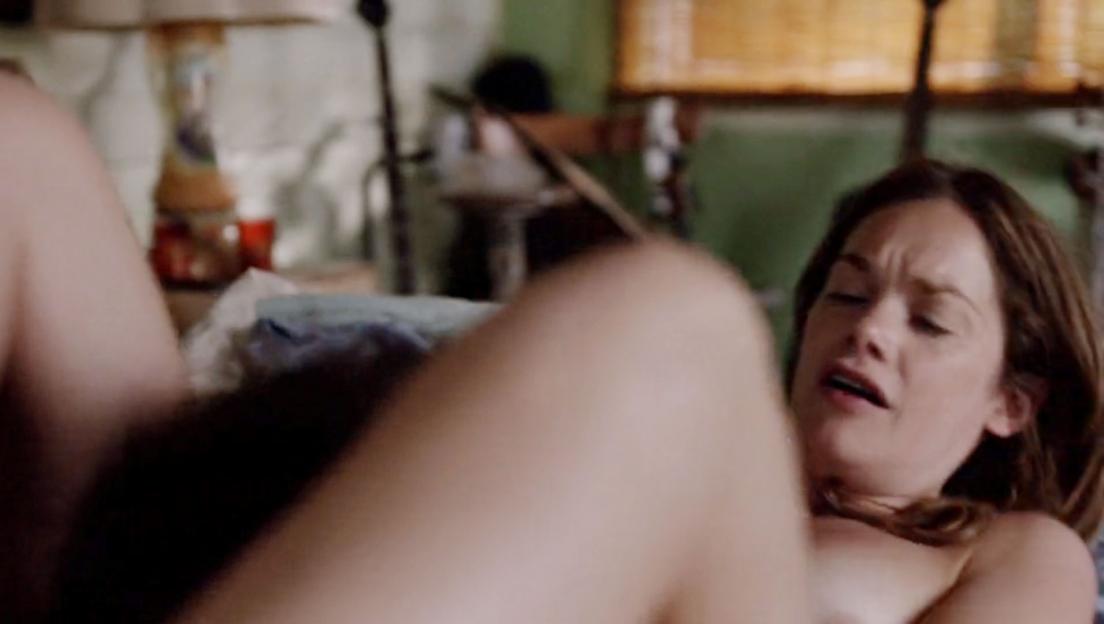 A woman with brown hair and an open mouth is shown in a steamy scene.