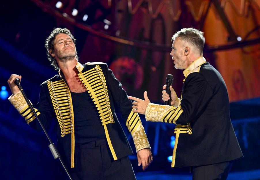 Howard Donald and Gary Barlow of Take That performing live on stage.
