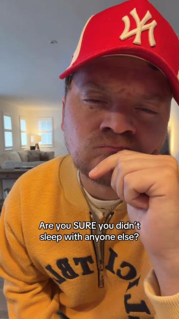 Conor Maynard in a red hat and yellow shirt, asking, "Are you SURE you didn't sleep with anyone else?"