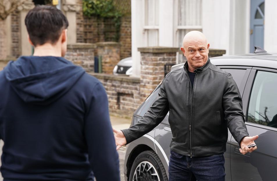 Grant Mitchell gestures toward Mark Fowler Jr, who has his back to the camera.