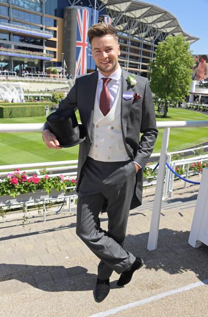Chris Hughes in a gray tailcoat and white waistcoat, holding a top hat, at Royal Ascot.