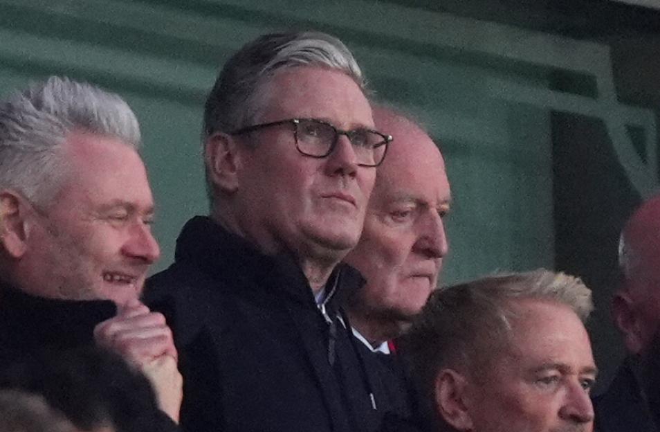 Prime Minister Sir Keir Starmer wearing glasses in the stands at Emirates Stadium.