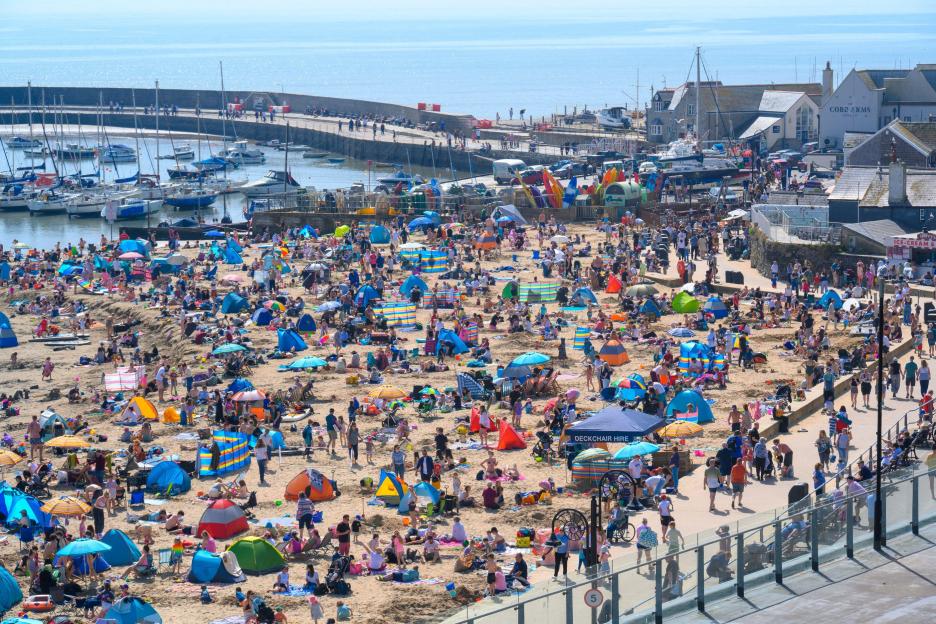 Lyme Regis, Dorset, UK. 25th April 2026. UK Weather: Visitors and locals soak up the hot sunshine on the beach at the seaside resort of Lyme Regis. Credit: Celia McMahon/Alamy Live News.
