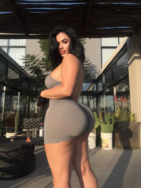 Lissa Aires posing in a gray outfit.