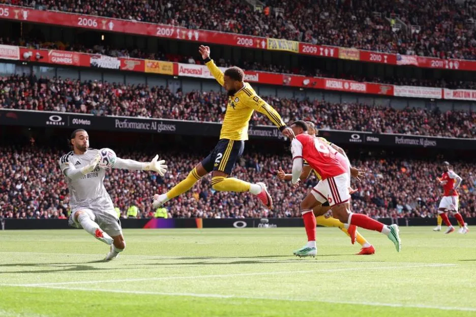 David Raya of Arsenal saves a shot from Jayden Bogle of Leeds United.