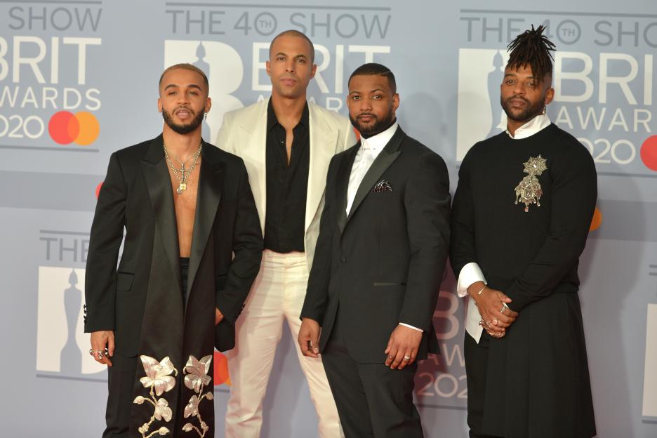JLS members Aston Merrygold, Marvin Humes, JB Gill, and Oritse Williams pose on the red carpet at The BRIT Awards 2020.