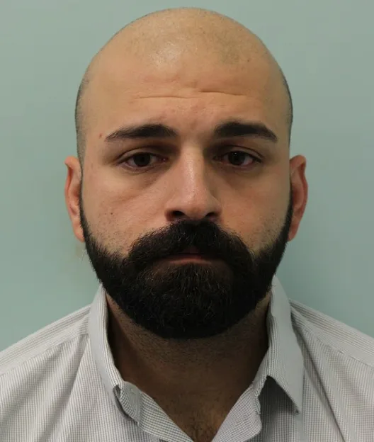 Police custody photograph of Hossein Mohmoudi.