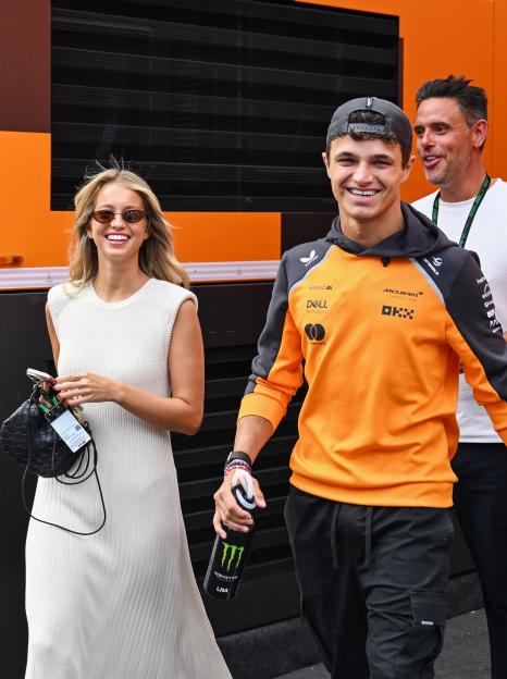 Lando Norris of Great Britain and McLaren, and Margarida Corceiro arrive in the Paddock ahead of the F1 Grand Prix of Hungary.