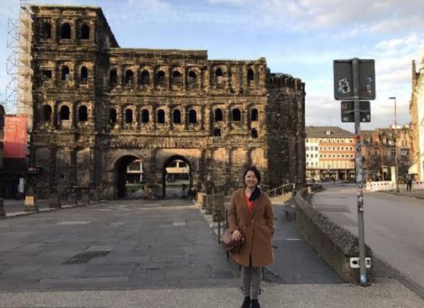 Jian Wen standing in front of the Porta Nigra in Germany.