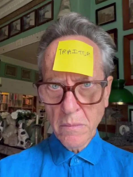 Richard E. Grant with a 'Traitor' note stuck to his forehead.