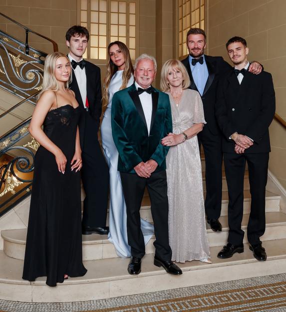The Beckhams and family pose on a grand staircase for Anthony Adams' 80th birthday.