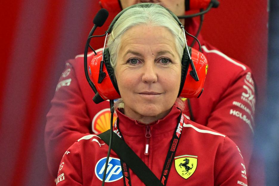 Angela Cullen, physiotherapist for Lewis Hamilton, wearing a red Ferrari jacket and red headphones, looks on during pre-season F1 testing.