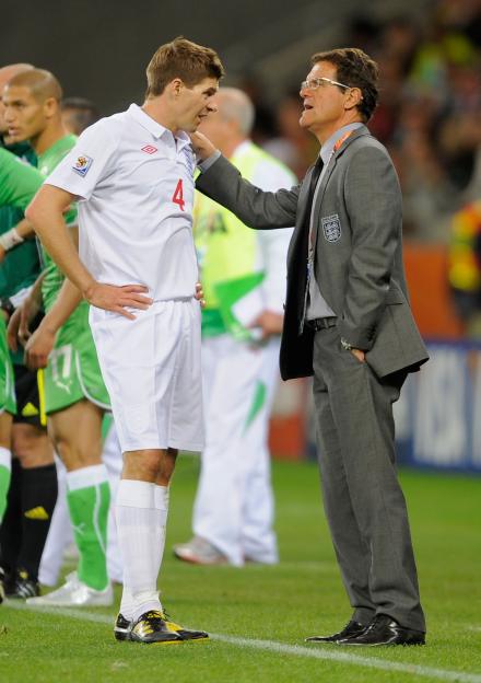 Fabio Capello, manager of England, speaking to Steven Gerrard of England.
