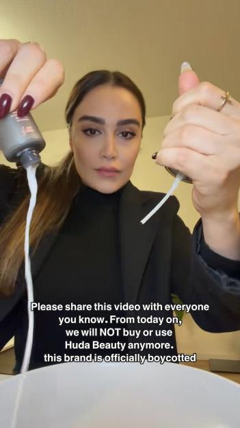 A woman pouring out a Huda Beauty product, boycotting the brand.
