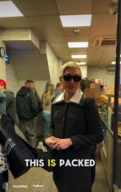 BryanBoy in a black coat and sunglasses stands in a crowded shop, with the text "THIS IS PACKED" overlaid.