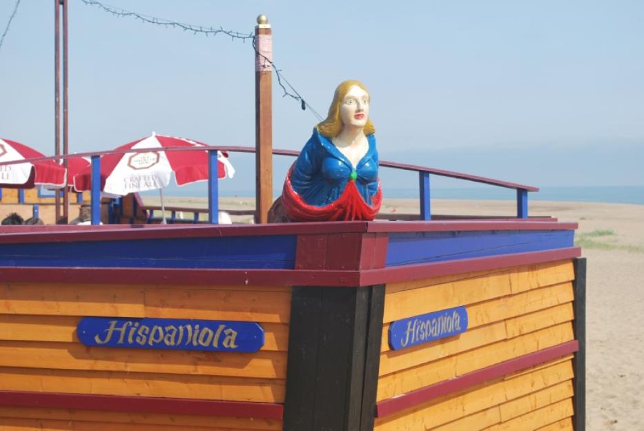 The Hispaniola beach bar, shaped like a ship, with a figurehead of a woman.