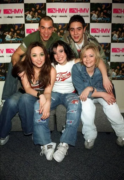 The British pop group Hear'Say pose together in front of an HMV backdrop.