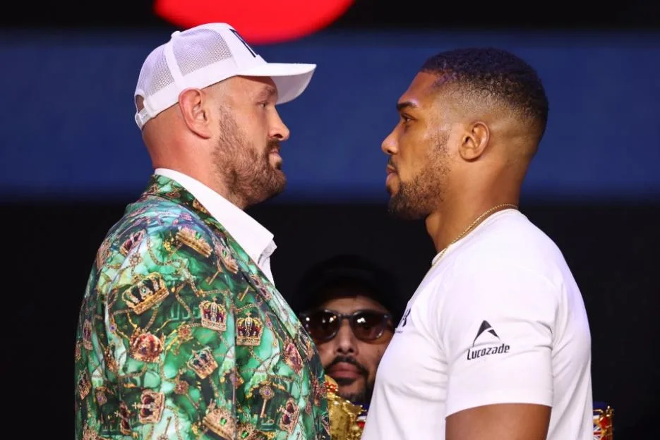 British boxers Tyson Fury and Anthony Joshua face each other during a press conference.