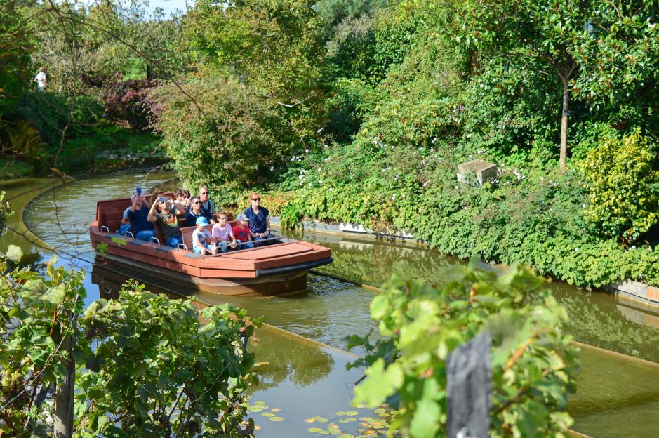 Tourists on a boat ride in Terra Botanica park.
