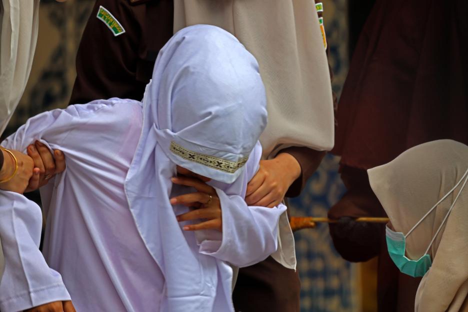 Banda Aceh, Aceh, Indonesia. 17th Sep, 2026. A convicted woman weeps and covers her face while being supported by female officers during a public caning execution at Taman Sari in Banda Aceh, Aceh province, Indonesia, on Thursday, Sept. 17, 2026. The