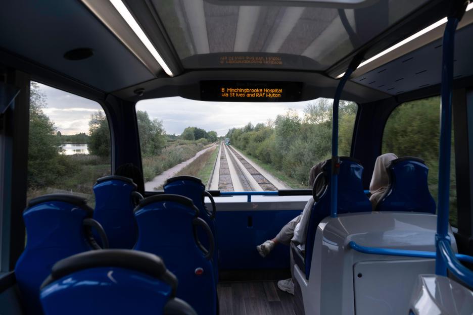 View from the top window of a Cambridgeshire double-decker bus on the Guided Busway, with another bus approaching on the tracks.