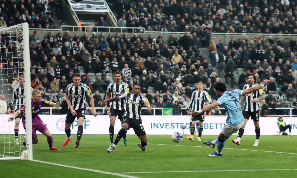 Omar Marmoush of Manchester City scores past Newcastle United's Aaron Ramsdale.
